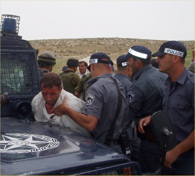 Non-violent villager being arrested
