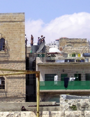 Settlers on balcony over Palestinian house